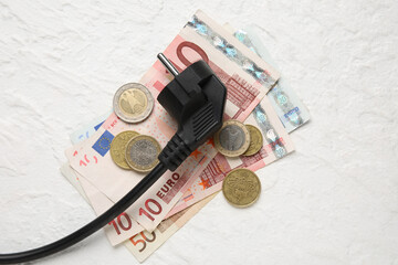 Plug with money on white background