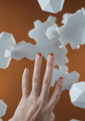 Artistic hand reaching towards dynamic geometric white shapes in motion