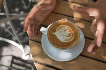 Barista art in a sunny outdoor cafe in the morning