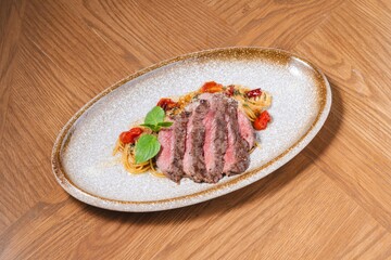 Grilled Beef Steak with Spaghetti Pasta on Rustic Plate