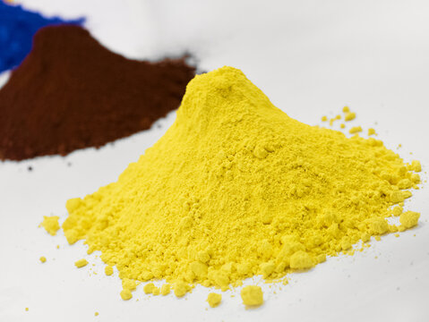 Colorful pigment powders create vibrant coatings for artistic surfaces during a creative workshop in an artist's studio