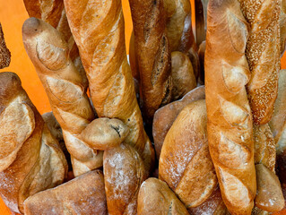 Freshly baked bread on display at a bustling market showcasing various artisanal loaves and vibrant textures in the warm glow of sunlight