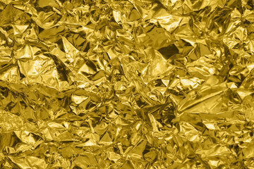 Fototapeta na wymiar Luxury shiny metallic golden foil crumpled texture background