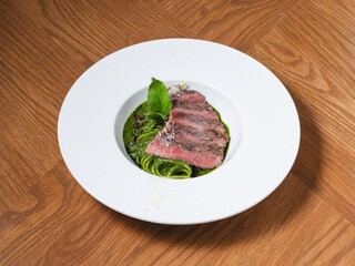 Grilled Beef Steak with Basil Pesto Spaghetti on White Plate