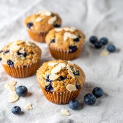 Paleo Coconut Flour Muffins with Fresh Blueberries and Almond Slivers on Rustic Linen Cloth