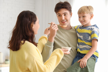 Parents with their little son cooking Fajita in kitchen