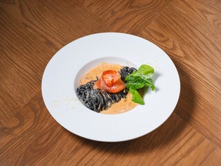 Squid Ink Pasta with Smoked Salmon and Cream Sauce on White Plate