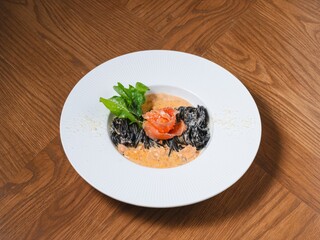 Squid Ink Pasta with Smoked Salmon and Cream Sauce on White Plate