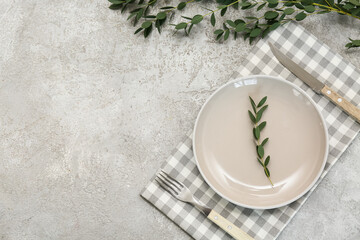 Beautiful table setting with eucalyptus branches on grey background