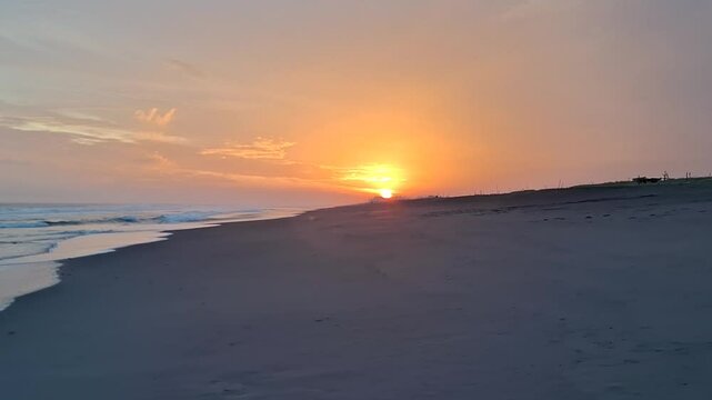 Magnificent Tropical Sunset on Black Sand Beach with Glowing Golden Sky, Waves Touching the Shoreline Gently and Rhythmically, Calm and Peaceful Atmosphere Perfect for Meditation Videos, Documentaries