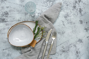 Beautiful table setting with gypsophila flowers and eucalyptus branches on grunge background
