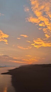 Tropical Sunset on the Beach with Unique Black Sand and Dramatic Golden Sky, Last Sunlight Touching the Sea Line, Soft Calming Waves, Romantic and Meditative Atmosphere Suitable for Background Music