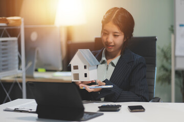 Real estate agents explain models of housing estates in projects to elaborate to clients,...