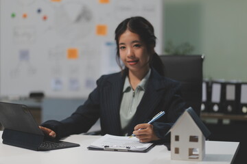 Real estate agents explain models of housing estates in projects to elaborate to clients,...