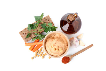Bowl of tasty hummus with carrot, garlic and chickpeas on white background