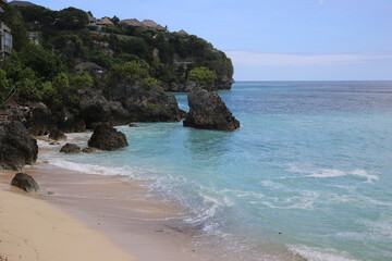 Golden Beach with Blue Ocean and Rocky Islets in the Background