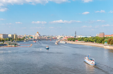 Naklejka premium Cruise ship sails on the Moscow river in Moscow city center, popular place for walking.