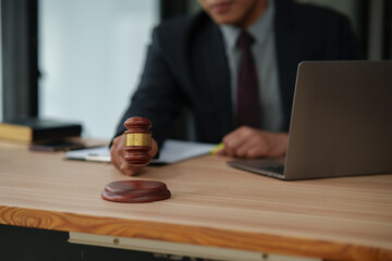 Male lawyer using phone, holding tablet, talking, giving legal advice, explaining to clients.
