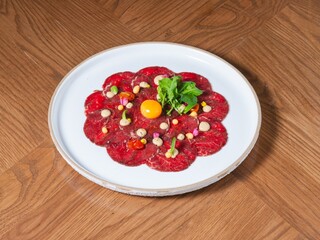 Beef Carpaccio with Raw Egg Yolk, Microgreens, and Gourmet Garnish