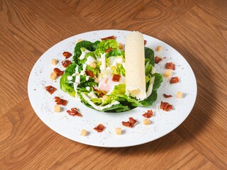 Caesar Salad with Crispy Bacon, Onsen Egg, and Croutons on White Plate
