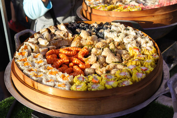 Assortment Asian dumplings in bamboo steamer