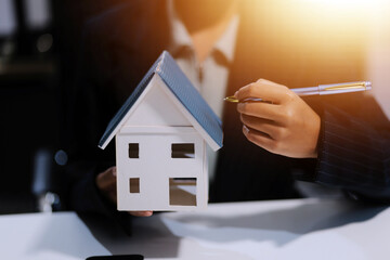 Real estate agents explain models of housing estates in projects to elaborate to clients,...