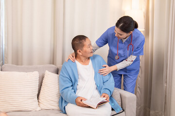 Obraz premium Nurse standing beside senior woman with book, both sharing a caring moment and discussing treatment at home, showing professional and emotional care, healthcare, caregiver, hospitality.