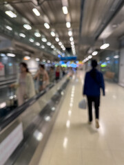 Blurred Airport Walkway with Travelers