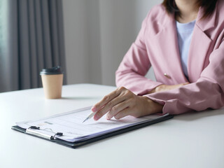 Businesswoman holding resume and interviewing new employee, evaluating, looking at applicant's...