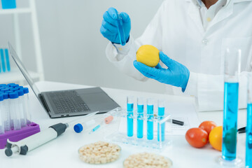 Scientist check chemical food residues in laboratory. Control experts inspect quality of vegetables...