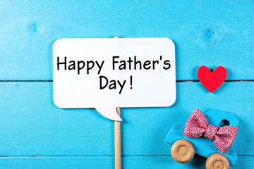 cup of coffee and a toy car with a happy fathers day sign