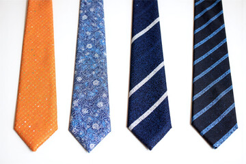 group of four different colored ties on a white background