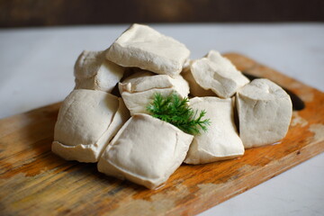 White tofu on wooden board 