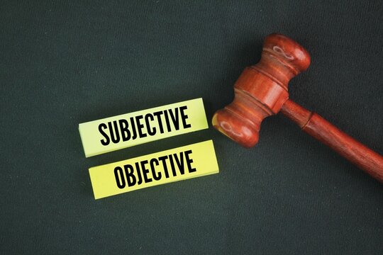 Judge's gavel and paper with the words subjective and objective.
