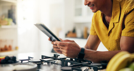 Tablet, kitchen and hands of man with online for recipe with cooking healthy, wellness or diet...