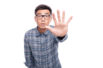 Naklejka premium Asian young male gesturing stop with hand in plaid shirt and glasses, cut out