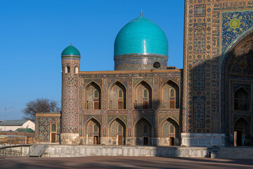 View of Tillya-Kari Madrasah and domed mosque building in the northern part of Registan Square on a sunny day, Samarkand, Uzbekistan