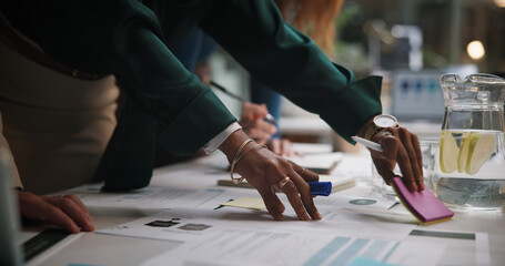 Night, business and hands of people with paperwork for planning, campaign management and agenda in office. Company team, workshop and sticky notes in workplace with documents, meeting and late tasks