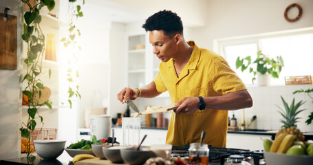 Banana, cooking and smoothie with man in kitchen of home for hobby, meal prep or nutrition. Fruit,...