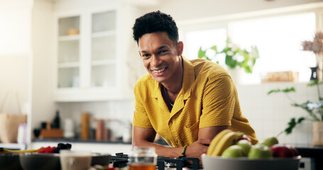 Cooking, portrait and smile with man in kitchen of home for hobby, meal prep or nutrition. Ingredients, career and recipe with happy person in apartment for diet, health or supper as culinary chef