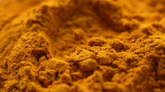 Macro video of turmeric powder kept on rotating disk. Close up of haldi powder.