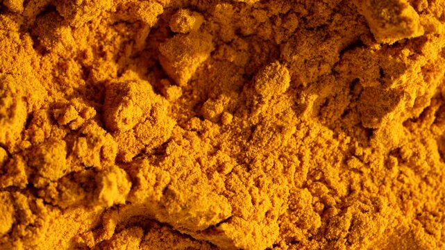 Macro video of turmeric powder kept on rotating disk. Close up of haldi powder.