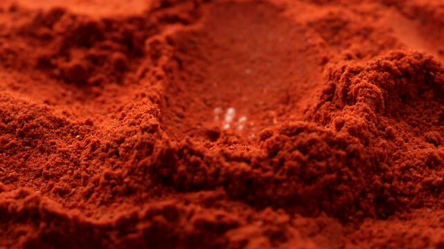 Macro video of red chilli powder kept on rotating disk. Close up of kashmiri chilli powder. 