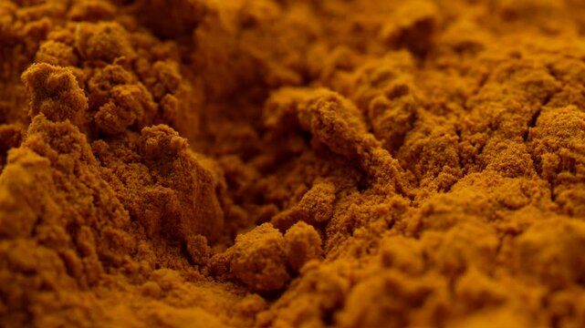 Macro video of turmeric powder kept on rotating disk. Close up of haldi powder.