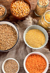 Ancient grains, seeds, beans in plates.