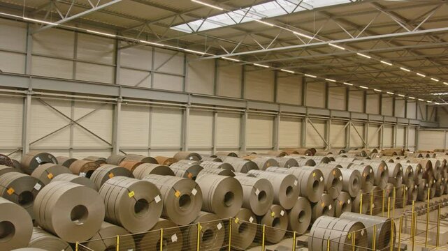 Wide pan of a large warehouse filled with large Strip steel coils