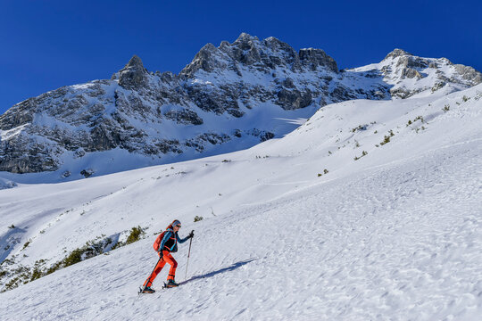 Woman back country skiing towards Grosser Priel with Brotfall in background, Totes Gebirge, Upper Austria, Austria