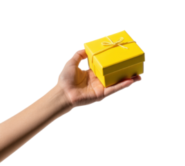 Yellow gift box held by hand on black background, cut out