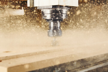 Cnc machine at carpentry workshop. Cutting wood with various router bits.