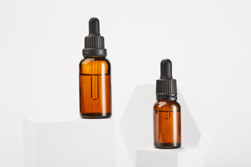 Two amber bottles with dropper pipettes for cosmetology.